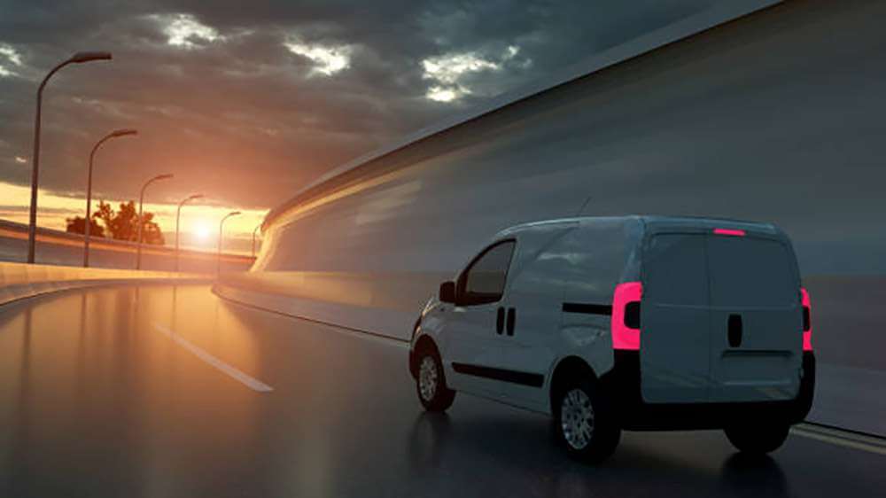 Courier vehicle travelling at night for an overnight delivery